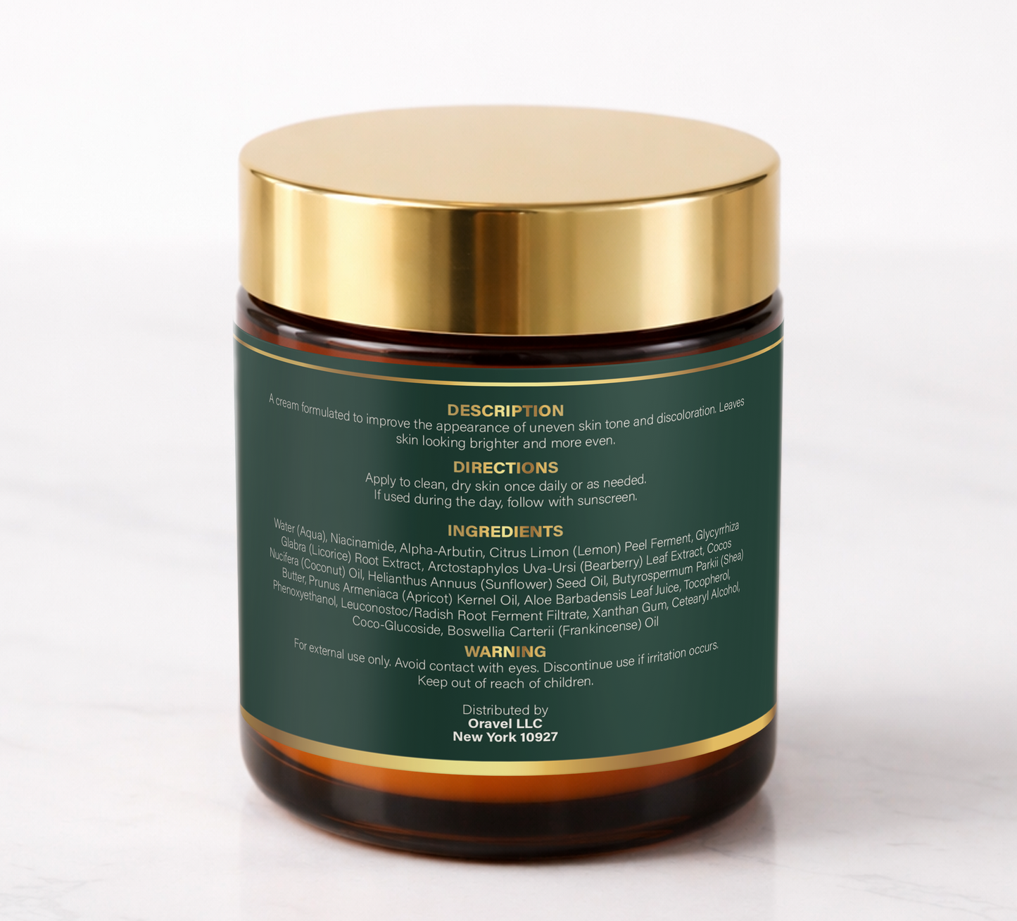 ORAVÉL Radiance Cream tone correcting cream in amber jar with gold lid on white marble surface