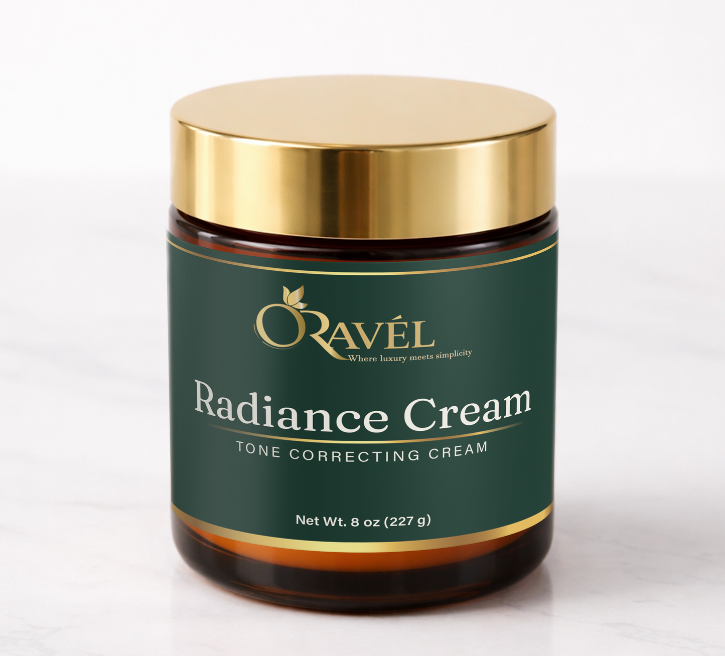 ORAVÉL Radiance Cream tone correcting cream in amber jar with gold lid on white marble surface